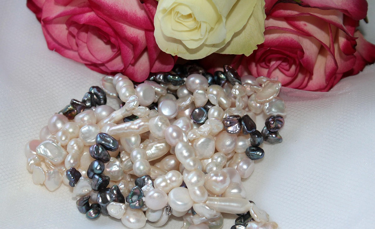 A string of lustrous pearls against a dark background, representing the beauty and cultural significance of pearls