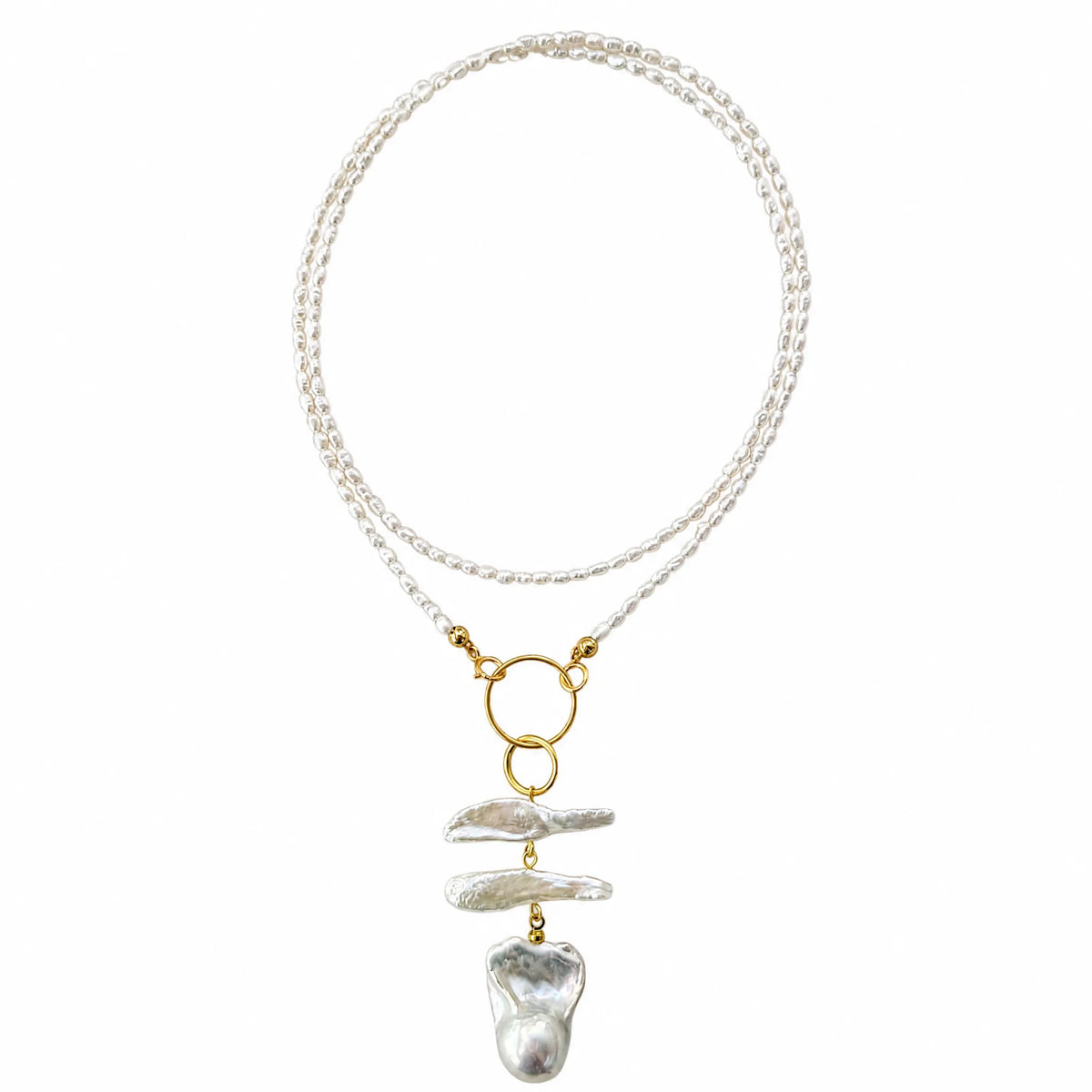 Layered seed pearl necklace with a baroque pearl pendant, flat lay on white background