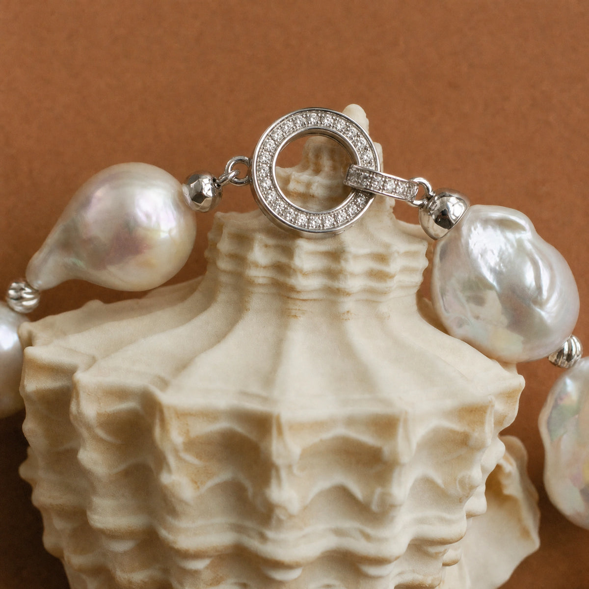 Close-up of the silver crystal clasp on a baroque pearl bracelet