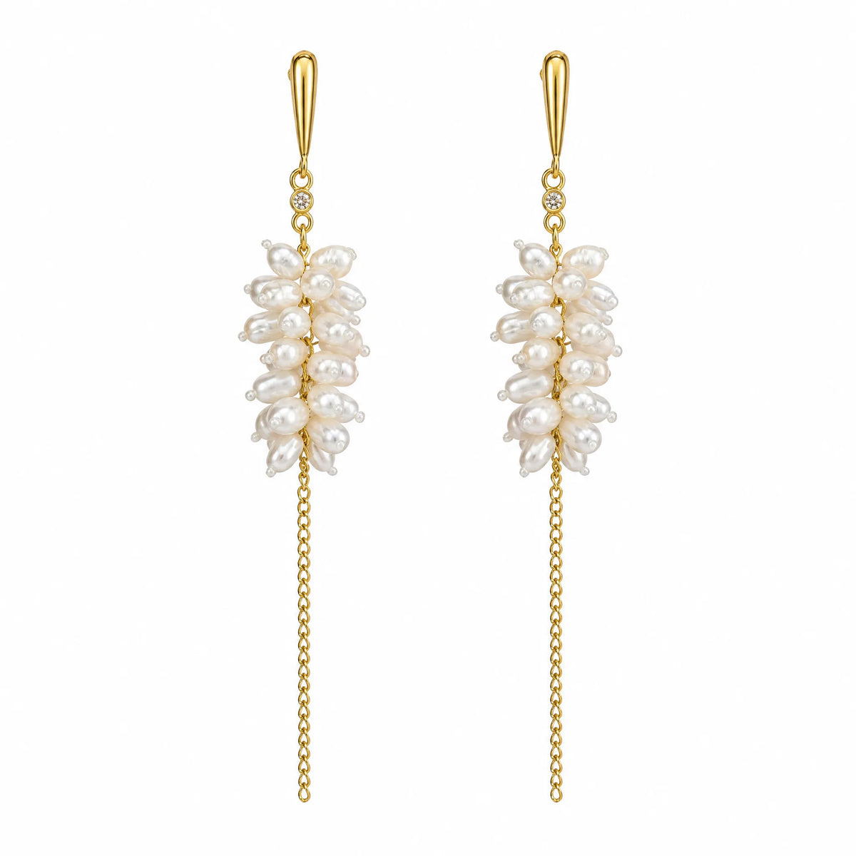 Pair of pearl blossom cluster earrings with crystal accent and gold chain drop, flat lay on white background